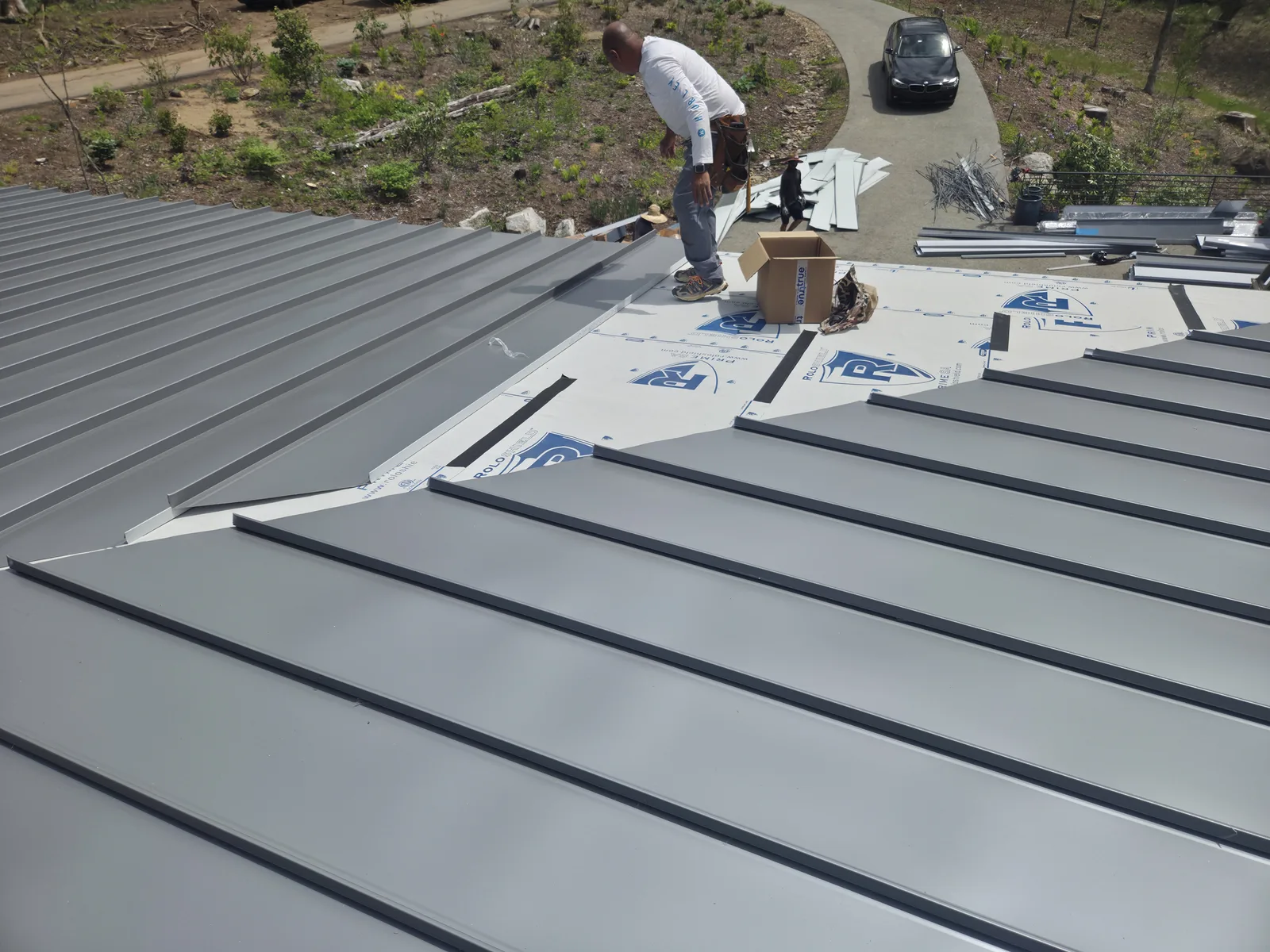 Installing standing seam metal roof panels