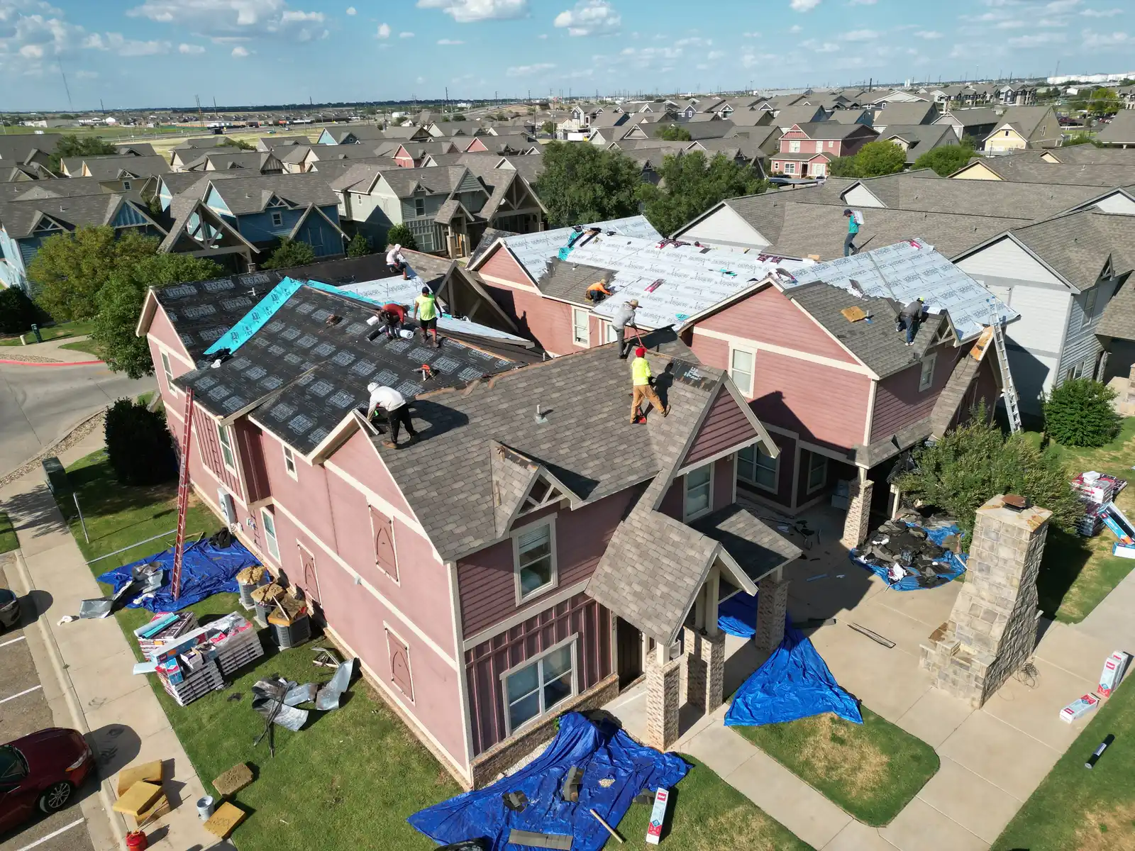 Roofing crew shingle install aerial